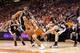 PHOENIX - MAY 05: Steve Nash #13 of the Phoenix Suns drives the ball past Tony Parker #9, Tim Duncan #21 and Manu Ginobili #20 of the San Antonio Spurs during Game Two of the Western Conference Semifinals of the 2010 NBA Playoffs at US Airways Center on