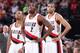 PORTLAND, OR - NOVEMBER 25: Damian Lillard #0, Wesley Matthews #2 and Nicolas Batum #88 of the Portland Trail Blazers stand on the court against the New York Knicks on November 25, 2013 at the Moda Center Arena in Portland, Oregon. NOTE TO USER: User exp