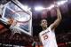 Mar 1, 2014; Charlottesville, VA, USA; Virginia Cavaliers guard Malcolm Brogdon (15) celebrates with the net after the Cavaliers game against the Syracuse Orange at John Paul Jones Arena. The Cavaliers won 75-56 and clinched the ACC regular season title.
