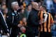 HULL, ENGLAND - MARCH 01: Fourth official Howard Webb restrains David Meyler of Hull City (7) after a clash with Alan Pardew manager of Newcastle United (L) during the Barclays Premier League match between Hull City and Newcastle United at KC Stadium on