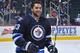 WINNIPEG, MB - JANUARY 25: Dustin Byfuglien #33 of the Winnipeg Jets smiles as he takes part in the pre-game warm up prior to NHL action against the Toronto Maple Leafs at the MTS Centre on January 25, 2014 in Winnipeg, Manitoba, Canada. (Photo by Lance T