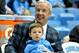 Roy Williams on the bench with his grandson.