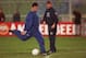22 NOV 1994: ERIC CANTONA OF MANCHESTER UNITED FIRES A SHOT AT GOAL DURING TRAINING TODAY AS CLUB MANAGER ALEX FERGUSON WATCHES IN THE BACKGROUND. CANTONA RETURNS TO THE SQUAD FOR THE EUROOEAN CHAMPIONS LEAGUE MATCH AGAINST GOTHENBURG TOMORROW AFTER A LO