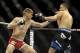 Feb 22, 2014; Las Vegas, NV, USA; Stephen Thompson (blue gloves) swings at Robert Whittaker (red gloves) with a left hook during their UFC welterweight bout at Mandalay Bay. Thompson won with a TKO in the first round. Mandatory Credit: Stephen R. Sylvanie