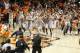 Mar 1, 2014; Stillwater, OK, USA; The Oklahoma State Cowboys and fans storm the court after defeating the Kansas Jayhawks at Gallagher-Iba Arena. Oklahoma State beat Kansas 72-65. Mandatory Credit: Tim Heitman-USA TODAY Sports