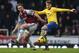 LONDON, ENGLAND - DECEMBER 26: Aaron Ramsey of Arsenal holds off Kevin Nolan of West Ham United during the Barclays Premier League match between West Ham United and Arsenal at Boleyn Ground on December 26, 2013 in London, England. (Photo by Ian Walton/G