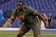 Alabama offensive lineman Cyrus Kouandjio runs a drill at the NFL football scouting combine in Indianapolis, Saturday, Feb. 22, 2014. (AP Photo/Michael Conroy)