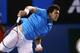 MELBOURNE, AUSTRALIA - JANUARY 20: Jo-Wilfried Tsonga of France serves in his fourth round match against Roger Federer of Switzerland during day eight of the 2014 Australian Open at Melbourne Park on January 20, 2014 in Melbourne, Australia. (Photo by C