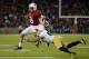 PALO ALTO, CA - NOVEMBER 30: Kevin Hogan #8 of the Stanford Cardinal gets tackled short of a first down by Matthias Farley #41 of the Notre Dame Fighting Irish during the third quarter at Stanford Stadium on November 30, 2013 in Palo Alto, California. (