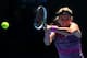 MELBOURNE, AUSTRALIA - JANUARY 22: Victoria Azarenka of Belarus plays a backhand in her quarterfinal match against Agnieszka Radwanska of Poland during day 10 of the 2014 Australian Open at Melbourne Park on January 22, 2014 in Melbourne, Australia. (Ph