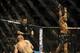 Feb 22, 2014; Las Vegas, NV, USA; Patrick Cummins (blue gloves) throws his hands up as Daniel Cormier lies on the mat after the referee stops their UFC light heavyweight bout at Mandalay Bay. Cormier won by way of a TKO in the first round. Mandatory Credi