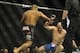Feb 22, 2014; Las Vegas, NV, USA; Patrick Cummins (blue gloves) falls to the mat after being hit by Daniel Cormier (red gloves) during their UFC light heavyweight bout at Mandalay Bay. Cormier won by way of a TKO in the first round. Mandatory Credit: Ste
