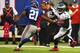 EAST RUTHERFORD, NJ - OCTOBER 06: Michael Vick #7 of the Philadelphia Eagles scrambles against Ryan Mundy #21 of the New York Giants during their game at MetLife Stadium on October 6, 2013 in East Rutherford, New Jersey. (Photo by Al Bello/Getty Image