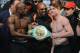 LAS VEGAS, NV - SEPTEMBER 13: CEO of Mayweather Promotions Leonard Ellerbe (C) looks on as boxer Floyd Mayweather Jr. (L) tries to get boxer Canelo Alvarez (R) to hold a WBC belt as they pose during the official weigh-in for their bout at the MGM Grand