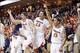 Mar 1, 2014; Charlottesville, VA, USA; Virginia Cavaliers guard Joe Harris (12), Cavaliers guard London Perrantes (23), and Cavaliers guard Malcolm Brogdon (15) celebrate on the bench in the final seconds against the Syracuse Orange at John Paul Jones Are