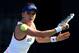 DUBAI, UNITED ARAB EMIRATES - FEBRUARY 19: Agnieszka Radwanska of Poland in action against Flavia Pennetta of Italy during day three of the WTA Dubai Duty Free Tennis Championship at the Dubai Tennis Stadium on February 19, 2014 in Dubai, United Arab Emi
