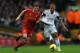 LIVERPOOL, ENGLAND - FEBRUARY 23: Jon Flanagan of Liverpool battles with Wayne Routledge of Swansea City during the Barclays Premier League match between Liverpool and Swansea City at Anfield on February 23, 2014 in Liverpool, England. (Photo by Clive B