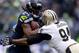 SEATTLE, WA - JANUARY 11: Running back Marshawn Lynch #24 of the Seattle Seahawks runs the ball against defensive end Cameron Jordan #94 of the New Orleans Saints in the first quarter during the NFC Divisional Playoff Game at CenturyLink Field on January