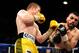 Mar 8, 2014; Las Vegas, NV, USA; Saul Alvarez (yellow gloves) trades punches with Alfredo Angulo during their super welterweight main event bout at MGM Grand Arena. Mandatory Credit: Stephen R. Sylvanie-USA TODAY Sports