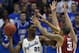 LAWRENCE, KS - FEBRUARY 24: Joel Embiid #21 of the Kansas Jayhawks looks to pass the ball against D.J. Bennett #31 of the Oklahoma Sooners in the second half at Allen Fieldhouse on February 24, 2014 in Lawrence, Kansas. Kansas won 83-75. (Photo by Ed Zu