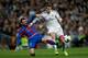 MADRID, SPAIN - MARCH 09: Gareth Bale (R) of Real Madrid CF competes for the ball with Nikos Karabelas (L) of Levante UD during the La Liga match between Real Madrid CF and Levante UD at Estadio Satiago Bernabeu on March 9, 2014 in Madrid, Spain. (Photo