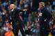 MANCHESTER, ENGLAND - MARCH 09: Wigan manager Uwe Rosler and Man City manager Manuel Pellegrini look on during the FA Cup Quarter-Final match between Manchester City and Wigan Athletic at the Etihad Stadium on March 9, 2014 in Manchester, England. (Phot