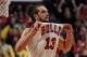 CHICAGO, IL - MARCH 09: Joakim Noah #13 of the Chicago Bulls pulls on his jersey in celebration at the end of a game against the Miami Heat at the United Center on March 9, 2014 in Chicago, Illinois. The Bulls defeated the Heat 95-88 in overtime. NOTE TO