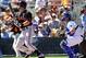 Mar 9, 2014; Glendale, AZ, USA; San Francisco Giants shortstop Brandon Hicks (14) hits a two run home run in the second inning against the Los Angeles Dodgers at Camelback Ranch. Mandatory Credit: Gary A. Vasquez-USA TODAY Sports