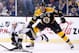 BOSTON, MA - DECEMBER 07: Sidney Crosby #87 of the Pittsburgh Penguins reaches for a puck in front of Zdeno Chara #33 of the Boston Bruins in the third period during the game at TD Garden on December 7, 2013 in Boston, Massachusetts. (Photo by Jared Wick