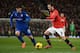 MANCHESTER, ENGLAND - JANUARY 28: Juan Mata of Manchester United competes with Kim Bo-Kyung of Cardiff City during the Barclays Premier League match between Manchester United and Cardiff City at Old Trafford on January 28, 2014 in Manchester, England. (