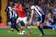 WEST BROMWICH, ENGLAND - MARCH 08: Robin van Persie of Manchester United takes on Youssuf Mulumbu (L) and Gareth McAuley of West Bromwich Albion (R) during the Barclays Premier League match between West Bromwich Albion and Manchester United at The Hawtho