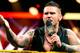 Corey Graves addresses the NXT audience and Yoshi Tatsu.