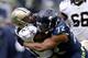 SEATTLE, WA - JANUARY 11: Running back Darren Sproles #43 of the New Orleans Saints is hit by defensive end Michael Bennett #72 of the Seattle Seahawks in the first half during the NFC Divisional Playoff Game at CenturyLink Field on January 11, 2014 in S