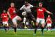 MANCHESTER, ENGLAND - SEPTEMBER 25: Victor Moses of Liverpool is challenged by Alex Buttner (l) and Jonny Evans of Manchester United during the Capital One Cup Third Round match betwen Manchester United and Liverpool at Old Trafford on September 25, 2013