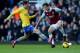 LONDON, ENGLAND - DECEMBER 26: George McCartney of West Ham United is challenged by Aaron Ramsey of Arsenal during the Barclays Premier League match between West Ham United and Arsenal at Boleyn Ground on December 26, 2013 in London, England. (Photo by