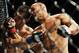 Jul 27, 2013; Seattle, WA, USA; Robbie Lawler (red tape) lands a punch to the head of Bobby Voelker (blue tape) during their welterweight bout at Key Arena. Lawler won by a TKO in the second round. Mandatory Credit: Jayne Kamin-Oncea-USA TODAY Sports
