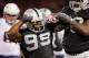 OAKLAND, CA - OCTOBER 06: Defensive end Lamarr Houston #99 of the Oakland Raiders celebrates a tackle against the San Diego Chargers in the first quarter on October 06, 2013 at O.co Coliseum in Oakland, California. The Raider lead 14-0 in the first qua