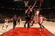 Bulls center Joakim Noah attempts to block the shot of Raptors guard DeMar DeRozan.