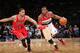 Wizards guard John Wall drives past Bulls guard D.J. Augustin.