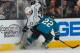SAN JOSE, CA - JANUARY 27: Dan Boyle #22 of the San Jose Sharks battles for the puck against Kyle Clifford #13 of the Los Angeles Kings during an NHL game on January 27, 2014 at SAP Center in San Jose, California. (Photo by Don Smith/NHLI via Getty Images