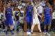 Kansas' Perry Ellis (34), Joel Embiid (21) and Andrew Wiggins (22) walk off the court during a timeout in the second half of an NCAA college basketball game against Texas, Saturday, Feb. 1, 2014, in Austin, Texas. Texas won 81-69. (AP Photo/Eric Gay)