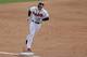LAKE BUENA VISTA, FL - MARCH 12: Freddie Freeman #5 of the Atlanta Braves touches third base following a third inning homerun against the Washington Nationals during a game at Champion Stadium on March 12, 2014 in Lake Buena Vista, Florida. (Photo by St