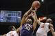 Mar 12, 2014; Las Vegas, NV, USA; Washington Huskies forward Desmond Simmons (30) shoots against Utah Utes guard/forward Princeton Onwas (3) and guard Delon Wright (55) during the first half in the first round of the Pac-12 Conference Tournament at MGM Gr