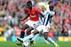 MANCHESTER, ENGLAND - MARCH 11: Paul Pogba of Manchester United is challenged by Marc-Antoine Fortune of West Bromwich Albionduring the Barclays Premier League match between Manchester United and West Bromwich Albion at Old Trafford on March 11, 2012 in