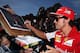 MELBOURNE, AUSTRALIA - MARCH 13: Fernando Alonso of Spain and Ferrari signs autographs for fans during previews to the Australian Formula One Grand Prix at Albert Park on March 13, 2014 in Melbourne, Australia. (Photo by Mark Thompson/Getty Images)