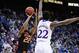 Mar 13, 2014; Kansas City, MO, USA; Oklahoma State Cowboys guard Markel Brown (22) shoots as Kansas Jayhawks guard Andrew Wiggins (22) defends during the first half in the second round of the Big 12 Conference college basketball tournament at Sprint Cente