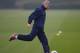 ST ALBANS, ENGLAND - MARCH 10: Arsenal manager Arsene Wenger kicks a ball during the Arsenal training session at London Colney on March 10, 2014 in St Albans, England. (Photo by Michael Regan/Getty Images)
