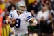 LANDOVER, MD - DECEMBER 22: Quarterback Tony Romo #9 of the Dallas Cowboys scrambles with the ball in the second half during an NFL game against the Washington Redskins at FedExField on December 22, 2013 in Landover, Maryland. (Photo by Patrick McDermot