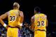 LOS ANGELES - 1988: Kareem Abdul-Jabbar #33 of the Los Angeles Lakers listens to Magic Johnson #32 during an NBA game at the Great Western Forum in Los Angeles, California in 1988. (Photo by Mike Powell/Getty Images)