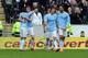HULL, ENGLAND - MARCH 15: Edin Dzeko (2 L) of Manchester City celebrates with team-mate Gael Clichy (L) after he scores the second goal of the game for his side during the Barclays Premier League match between Hull City and Manchester City at the KC Stad